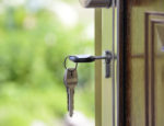 Keys unlocking a door